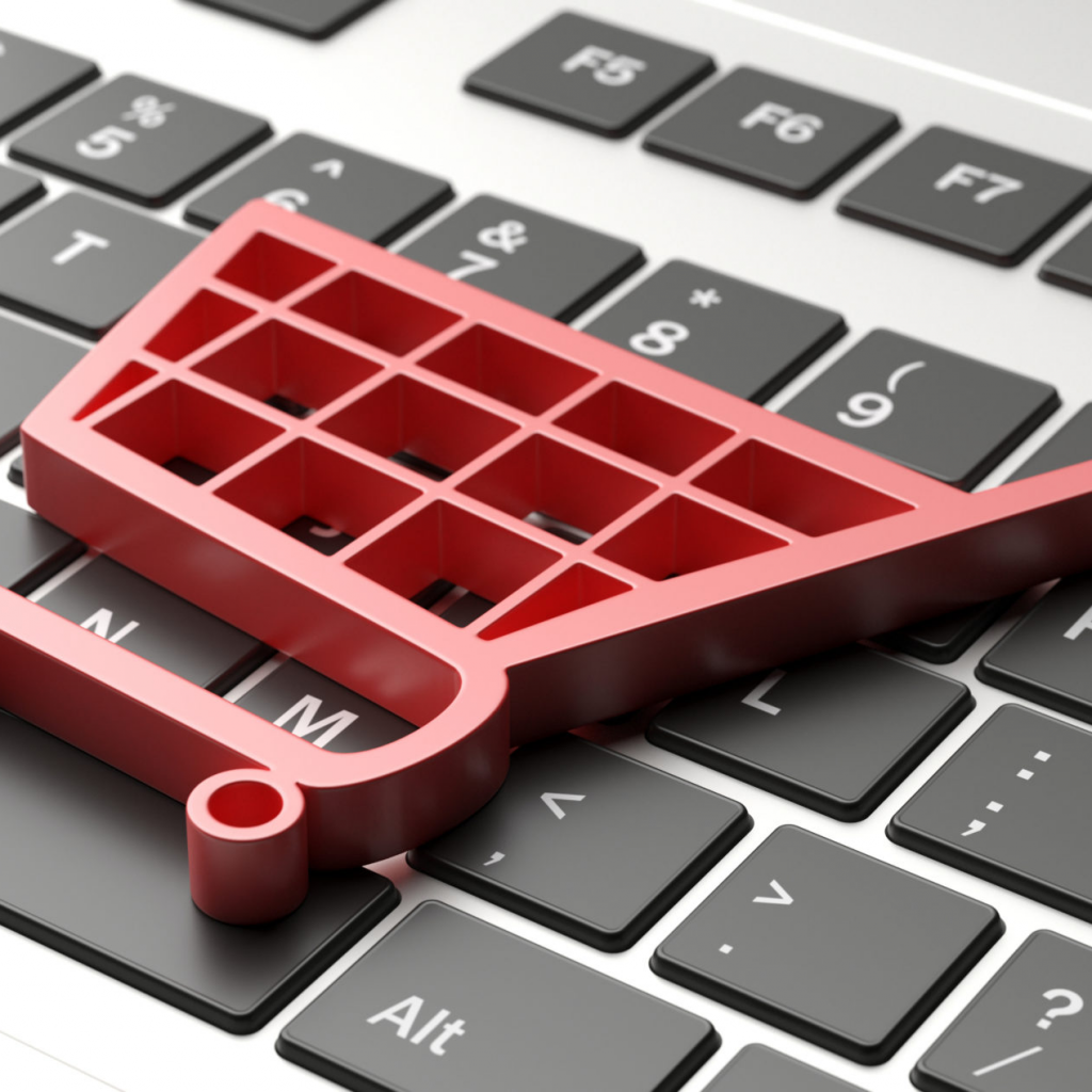 Roter Einkaufswagen auf einer Tastatur