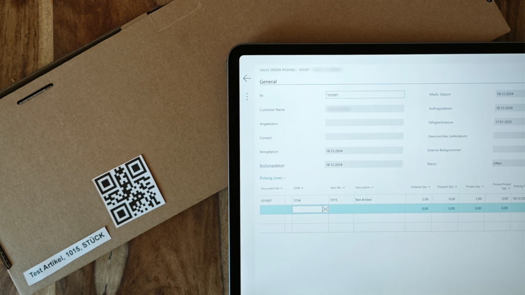 Tablet scannt QR-Code an einem Paket
